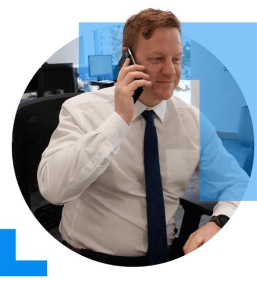 A business sales professional speaks on the phone to a client, responding the queries regarding business exit strategies and retirement.