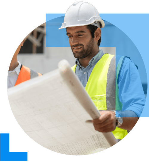 A construction worker wearing a white hard hat, analysing the blueprint for an ongoing project, symbolising the Construction sector.