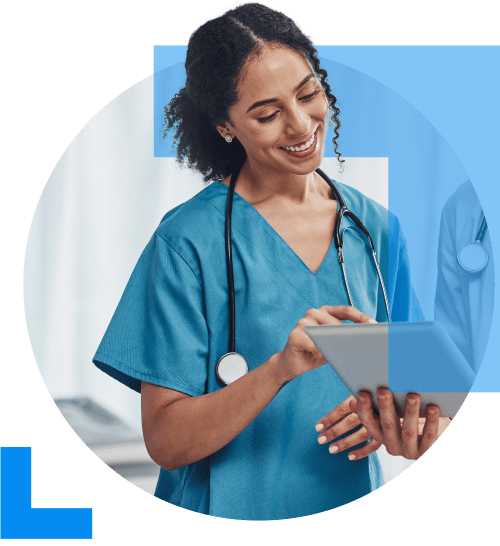 A doctor in blue medical attire smiles while pointing at a clipboard held by a colleague, representing the Healthcare sector.