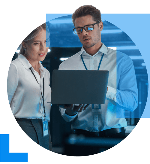 An IT specialist shows a laptop screen to a colleague, representing the IT & Software sector.