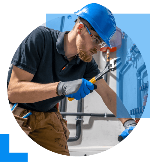 A plumber wearing work clothes and a blue hard hat, holding a large spanner in one hand, symbolising the plumbing sector.