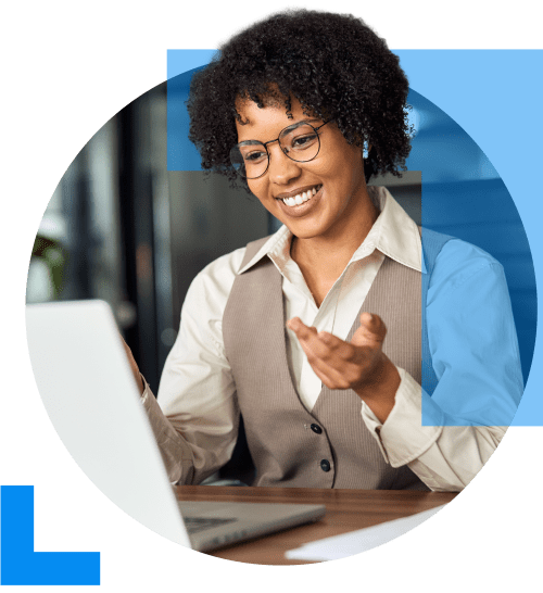 A friendly professional consultant uses a laptop, engaged in a conversation with a client, representing the Professional Services sector