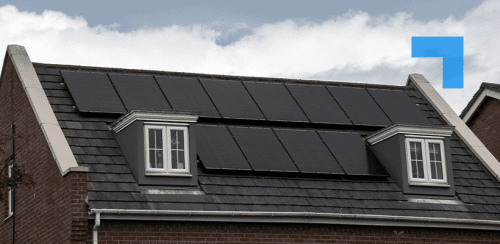 Photo of a modern British house in the UK with electrical solar panels on the roof on a bright sunny day with clouds in the sky