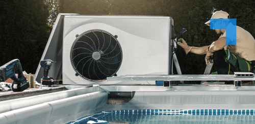 A worker installs or repairs a heat pump unit next to an outdoor swimming pool.