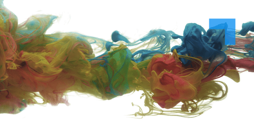 A vivid abstract image showing clouds of colored ink — yellow, green, blue, and red — swirling and merging together in water against a bright white background. The colors form soft, fluid tendrils and waves that intertwine, creating a dynamic sense of motion and blending.