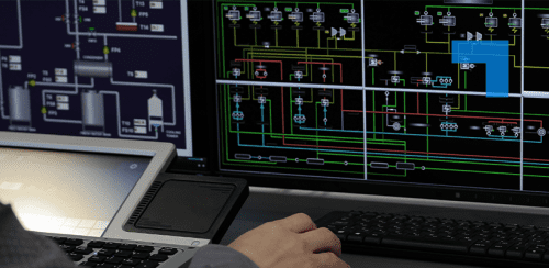 Close-up of a person’s hand on a keyboard in front of multiple computer monitors displaying complex technical schematics and system diagrams, with a laptop positioned to the left.