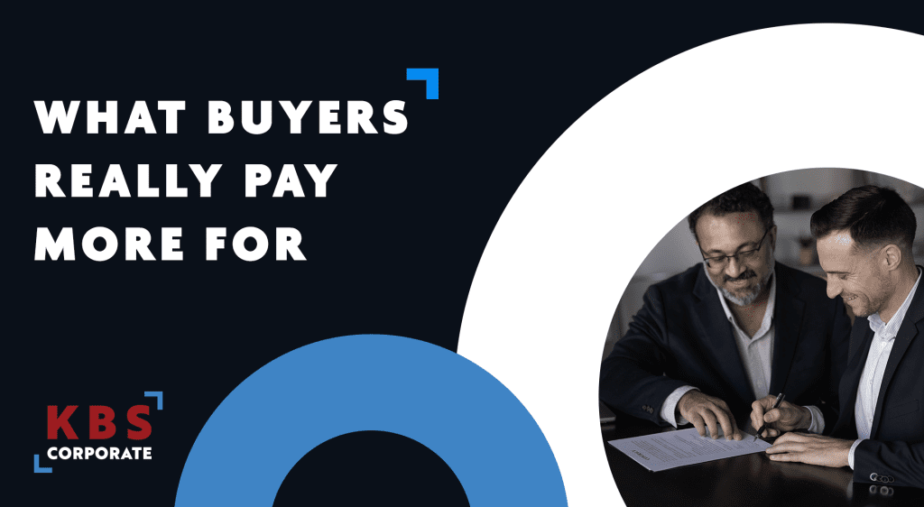 Businessmen reviewing a contract, next to text "What buyers really pay more for"